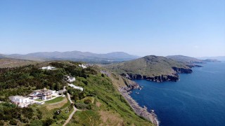 Aerial view of Dzogchen Beara with blue sea below