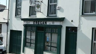 The exterior of O'Regans Bar, an old, traditional pub facade