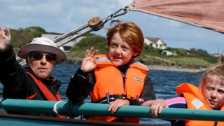 a family group sailing in the sunshine in Roaring Water Bay