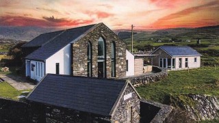 Allihies Copper Mines Muesum with a sunset sky behind it